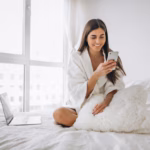 woman-working-computer-bed-talking-phone_1303-13312